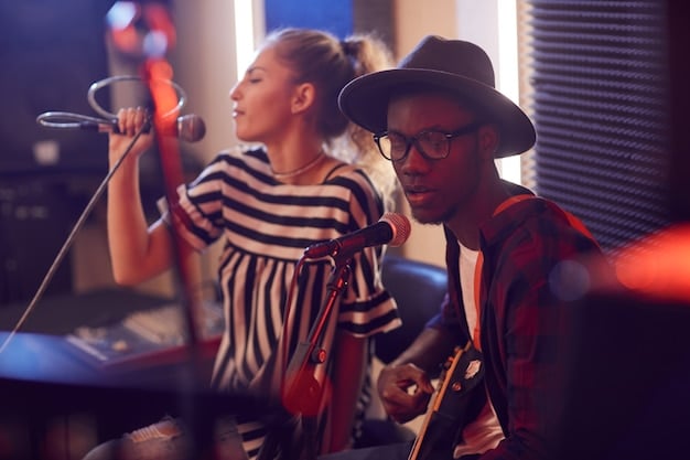 A group of diverse music students collaborating in a modern recording studio, surrounded by sound equipment and instruments. The environment is energetic and focused, showcasing the collaborative aspects of music education.