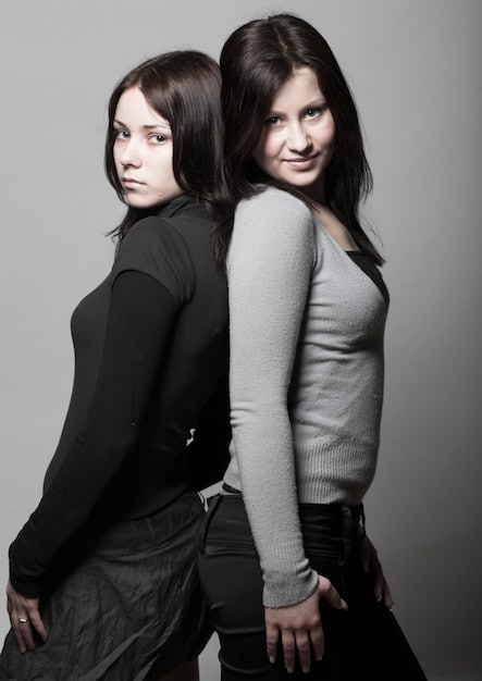 A side-by-side comparison of Kim Kardashian and Kylie Jenner: on one side, Kim posing for SKIMS advertisement, and on the other, Kylie showcasing a Kylie Cosmetics product, highlighting their respective brands.