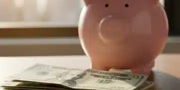 Stack of US dollar bills next to a ceramic piggy bank, representing a growing emergency fund.